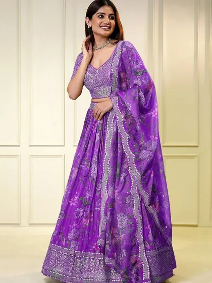 Make a bold statement in this purple organza lehenga. The sequined blouse and floral printed skirt create a look that's both glamorous and graceful.