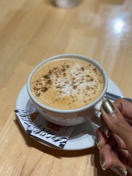A simple cup of cappuccino, perfectly made. It's the little things, like a warm coffee on a Friday, that make life feel good.