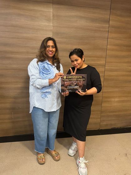 Proudly holding my certificate of completion from the advanced hairstyling workshop. I am committed to bringing international techniques and skills to my students and clients in Karur.