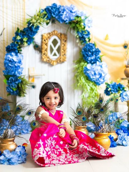 This little Radha is all smiles in our beautiful Vrindavan-inspired set. The bright pink lehenga stands out beautifully against the blue and gold decor.