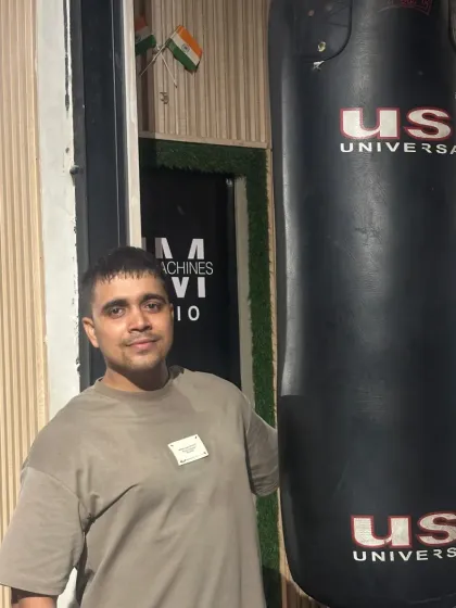 Standing next to the punching bag, a great tool for cardio and power.