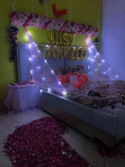Another view of the first-night room decoration, showing the beautiful path of rose petals leading to the bed.