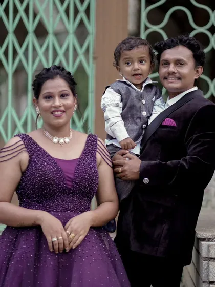 A portrait of another family from the same group shoot. The mother wears a lovely beaded purple gown that complements her family's attire.