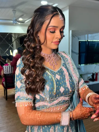 A candid moment of the bride getting ready, her hair and makeup looking perfect.