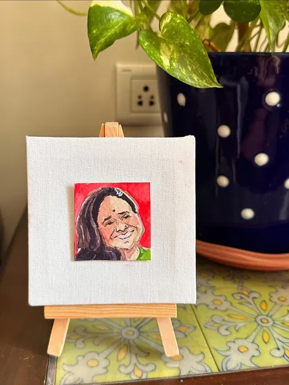 My mini portrait of my mom displayed on an easel.