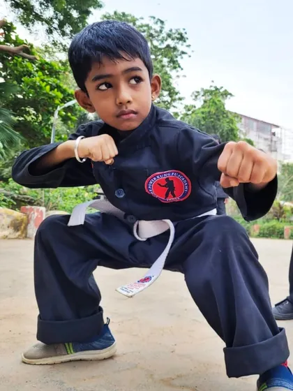 This young student, with his white belt, shows the determination and spirit we foster in our kids' martial arts program.