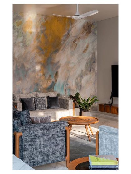 A family lounge in the 'Solid Void Solid' house featuring a custom abstract wallpaper that adds texture and depth. The design focuses on creating a comfortable, intimate zone for relaxation, with carefully selected furnishings and soft lighting.
