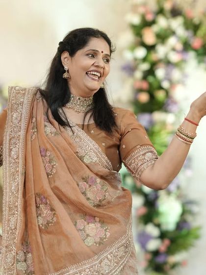 A beautiful candid shot of the groom's mother during her performance. Her expression is full of joy and grace, a moment captured perfectly.