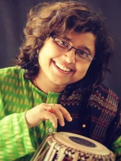 A portrait of the brilliant tabla player Ms. Rimpa Siva, whose artistry represents the high standards of Indian classical music we uphold.