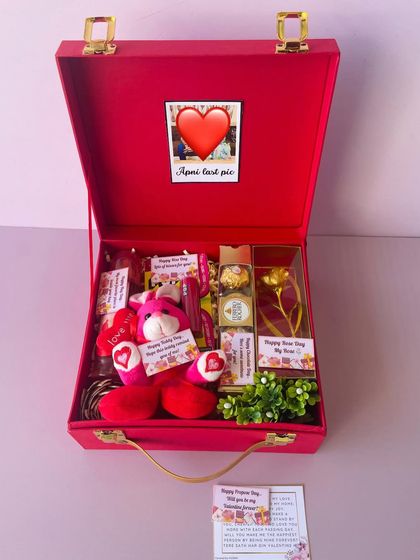 A Valentine's week hamper with 7 days of gifts packed into one red suitcase box. It includes a teddy, chocolates, and other surprises for a week of love.