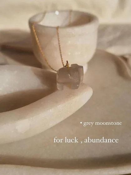 The grey moonstone 'haati' elephant pendant, a charm for luck and abundance. Its gentle energy helps to soothe emotional instability.