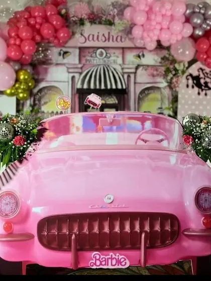 Let's go party! For this Barbie-themed event, I created a life-sized photo opportunity with a classic pink convertible, surrounded by a glamorous balloon arrangement. It's all about creating those fun, picture-perfect moments.