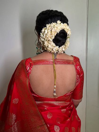 The back view showing a classic gajra bun, a timeless choice for a reception.