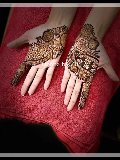 An elegant, asymmetrical design perfect for an engagement or sangeet. One hand features a geometric pattern, while the other has a more organic, flowing design, creating a modern and artistic look.