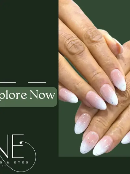 A soft and subtle glitter ombre on almond-shaped nails. The fine, silvery glitter fades gently from the tip, creating a delicate and clean look.