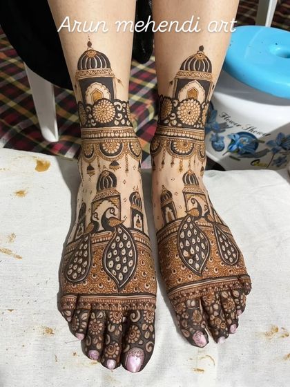 A beautiful and bold foot mehendi design with large peacock motifs and architectural details, ensuring your feet get all the attention.
