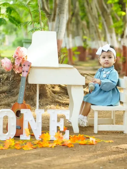Celebrating one year of sweetness. This outdoor setup with a mini piano and guitar is perfect for capturing the curious and playful spirit of a one-year-old.