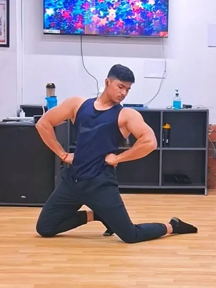 A member practicing a classic bodybuilding pose, showcasing the definition and symmetry earned through consistent training.