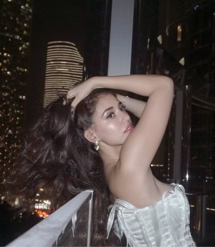 A stunning shot against the Dubai skyline. The city lights add a magical backdrop to this glamorous hair and makeup look.