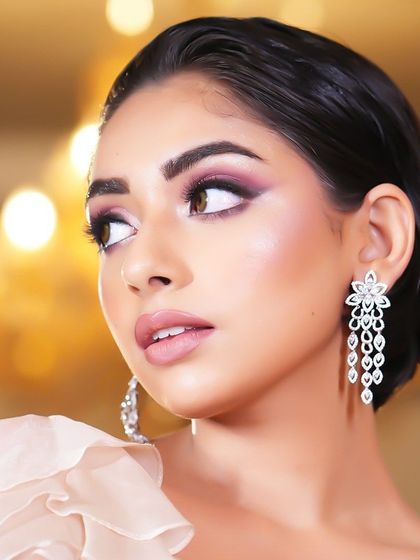 A side profile, showing the beautiful details of the eye makeup and the wet-look hair.