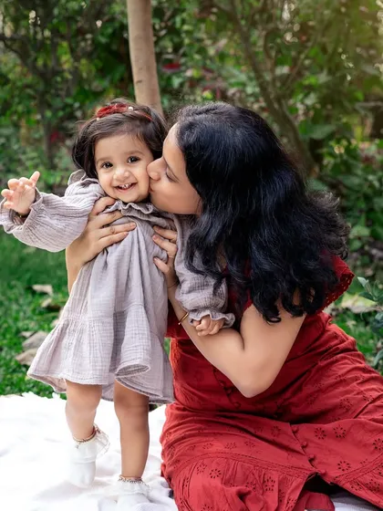 A sweet kiss for a happy toddler. These tender moments of affection are what make outdoor family photoshoots so incredibly special and memorable.
