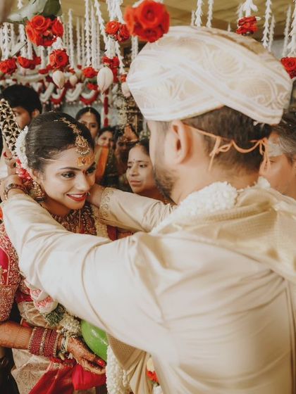 The groom tying the sacred thread, a pivotal and emotional moment of the wedding ceremony.