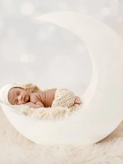 A journey to the stars on my custom moon prop. This dreamy, all-white setup is a client favorite, creating serene and angelic portraits that feel timeless. The soft textures and lighting are designed to highlight your baby's delicate features.