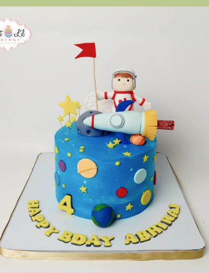 Blast off to a sweet celebration with this space adventure cake. A fondant astronaut and rocket sit atop a planet-adorned tier, making it an out-of-this-world treat for a 4th birthday.