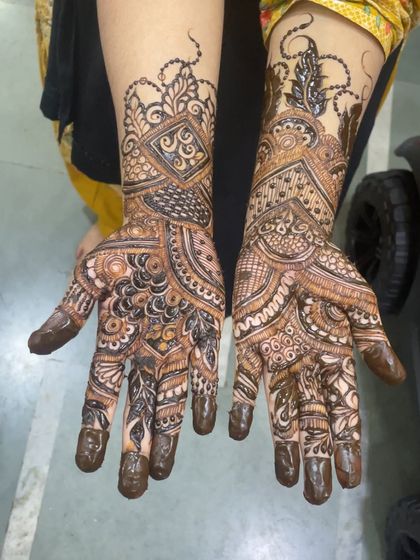 Another angle of this intricate bridal design, showing how the patterns on both hands complement each other perfectly.