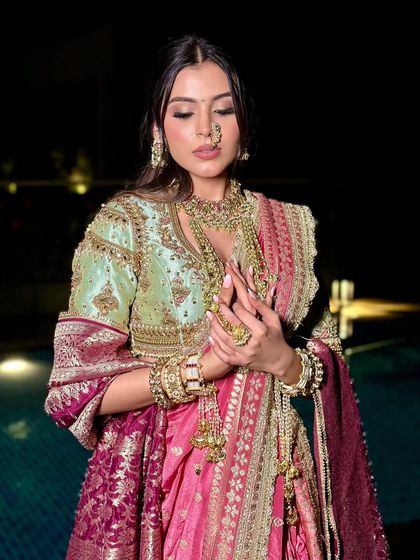 This image showcases the intricate details of the jewelry and the soft, glowing makeup that ties the entire look together.