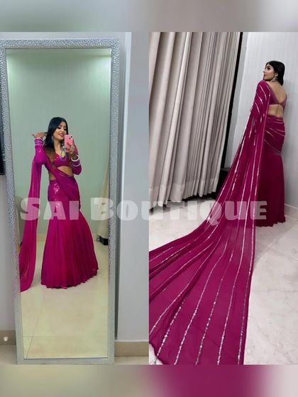 A mirror selfie showing off this gorgeous magenta saree with a long, dramatic pallu. It's a true showstopper.