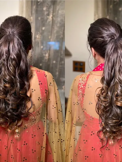 A back view of the high ponytail, showing the seamless blend of the ponytail and the voluminous curls.