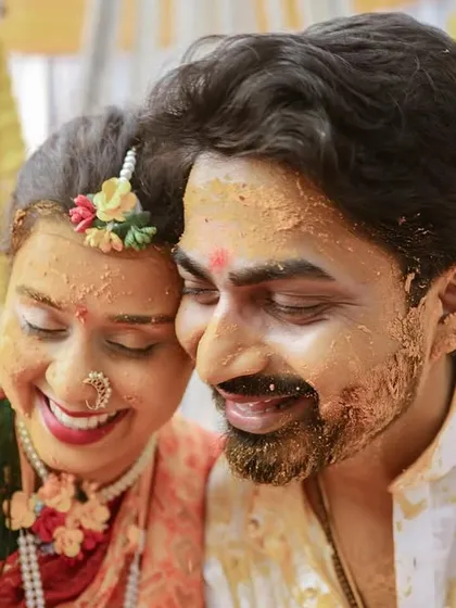 A tender moment amidst the fun of the Haldi ceremony. Even covered in turmeric, the couple's love and connection shines through.