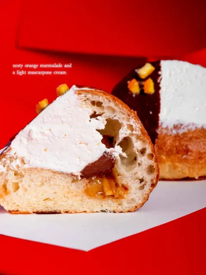 A cross-section reveals the zesty orange marmalade and light mascarpone cream inside the bun.