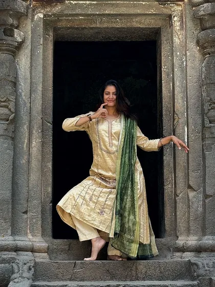 A playful pose at the entrance of a cave temple at Ellora. The architecture itself feels like a dance.