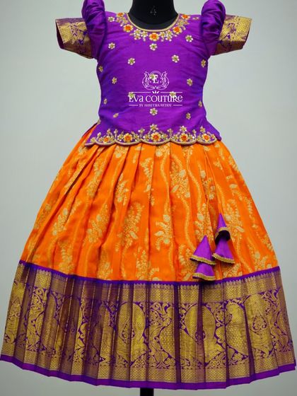 Another look at the orange and purple Banarasi lehenga, showing the puff sleeves and cute tassels.