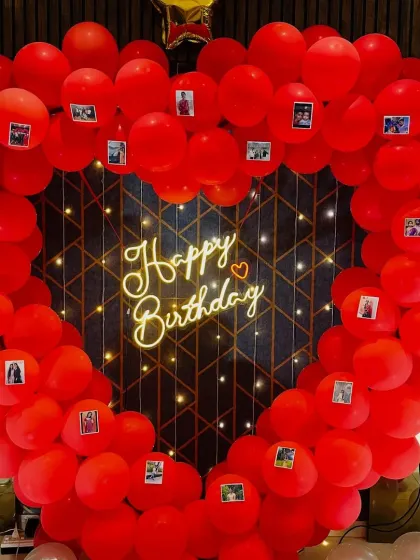 A close-up of the personalized heart balloon frame, showing the small photos attached to the balloons.