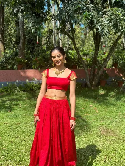 For a bold and joyful celebration, I designed this vibrant red crop top and skirt set. The modern silhouette with a square neckline is balanced with traditional gold detailing on the sleeves, creating a perfect fusion look for a Sangeet or pre-wedding event.