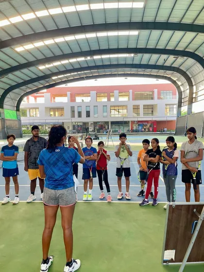 A wide shot of a mentorship session on our covered courts. We leverage our world-class facilities to host inspiring events for our players.