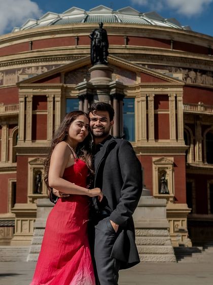 A classic couple portrait with the Royal Albert Hall as a stunning backdrop. Their warm embrace and smiles show their happiness during this special destination photoshoot.