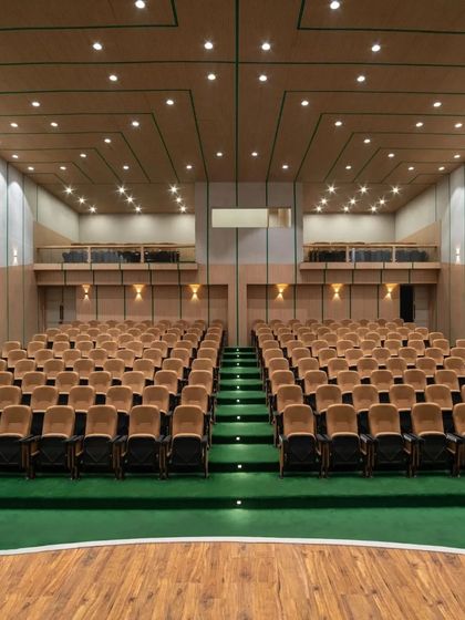 The building includes a modern auditorium with excellent acoustics and comfortable seating, designed to host party meetings and public events.