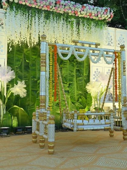 Every detail matters in creating a beautiful setting. This view shows the decorated cradle, the large paper flowers, and the lighting fixtures I used to enhance the overall stage design for this naming ceremony.