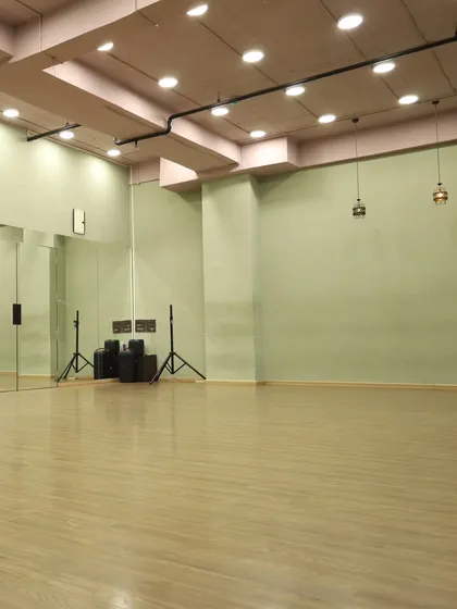 Another angle of our spacious studio, highlighting the professional speakers and open floor plan, ideal for workshops and classes.