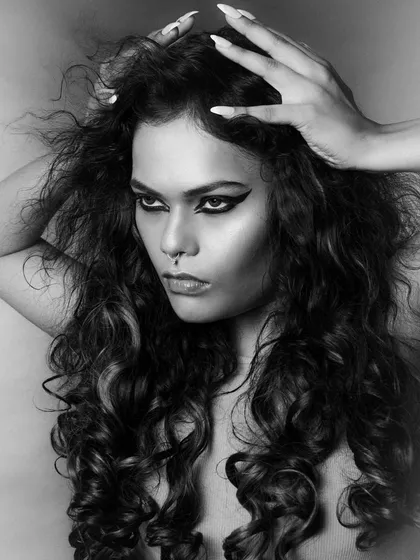 A fierce and dramatic black and white portrait. I created a bold, graphic winged liner and styled the hair with a lot of volume and texture to create this powerful, wild look.