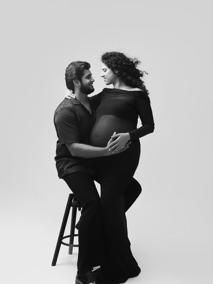 The love and connection are palpable in this black and white portrait. The way they look at each other tells a story of a shared journey and deep affection.