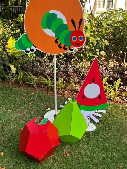 More props from the storybook world, featuring the caterpillar peeking through an orange. These standalone pieces are great for decorating different corners of the event space and reinforcing the party's theme.