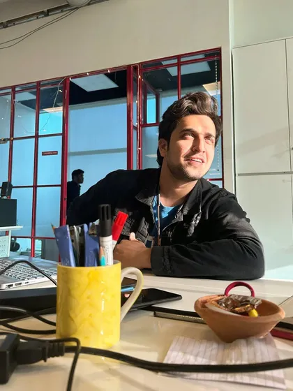 Caught in a moment of thought between takes. Even when not in the main frame, I stay engaged and ready for my cue. Just absorbing some Vitamin D while working!