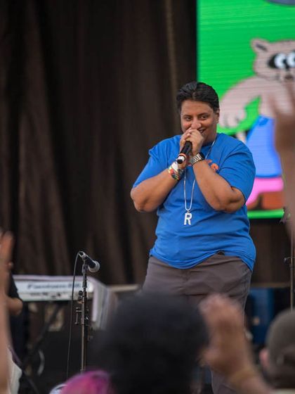 On the mic, getting the crowd hyped at Basement Bhangra. As the producer and DJ, I'm deeply involved in the energy of the event, making sure the connection between the stage and the audience is strong.