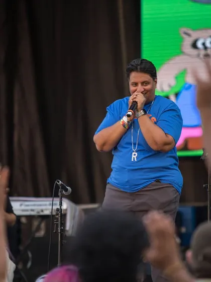 On the mic, getting the crowd hyped at Basement Bhangra. As the producer and DJ, I'm deeply involved in the energy of the event, making sure the connection between the stage and the audience is strong.