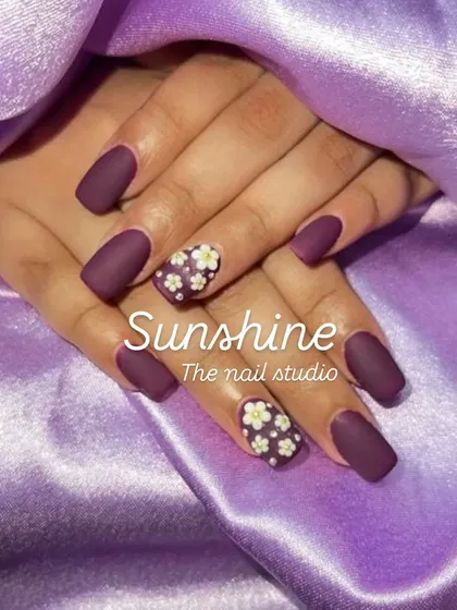 A beautiful matte purple set with a delicate, hand-painted floral accent nail. This design combines a solid modern color with classic, detailed artwork.